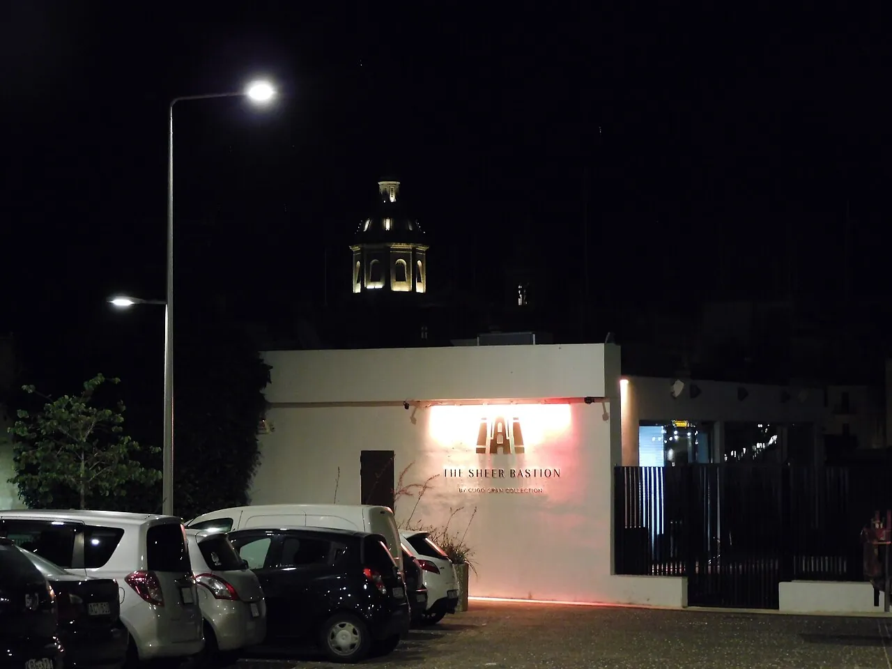Cugó Gran Macina entrance and historic tower after dark